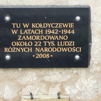 Мемориальная доска с текстом на польском языке.