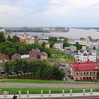 Вид с крепостных стен Кремля у Тайницкой башни на городские постройки. Справа - Казанский храм, перед ним - бывший доходный дом Бугровых, в центре - Ильинский храм, за ним - стрелка Оки и Волги.