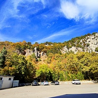 Автостоянка перед храмовым комплексом Архистратига Божия Михаила на Севастопольском шоссе над посёлком Ореанда. Выше - ребро склона горы Ай-Никола с Крестом и Распятием на навершие выступа скалы.