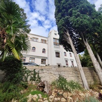 Дворц.-парк. ансамбль "Дюльбер". Построен с 1895 по 1897 г. Инициатор - велик. князь П. Н. Романов. Проект всего ансамбля с учётом эскизов Романова разраб. ялт. арх. Н. П. Краснов, парк высажен с участ.  крым. садовода Л. Кремера. Дворец "Дюльбер".