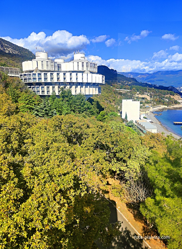 Вид с канатной дороги санатория "Горный" в п.г.т. Курпаты на южный склон Ай-Петринского массива Черноморскую акваторию и побережье,  корпус "Дружба" («летающая тарелка») комплекса «Курпаты» Управления делами Президента РФ.