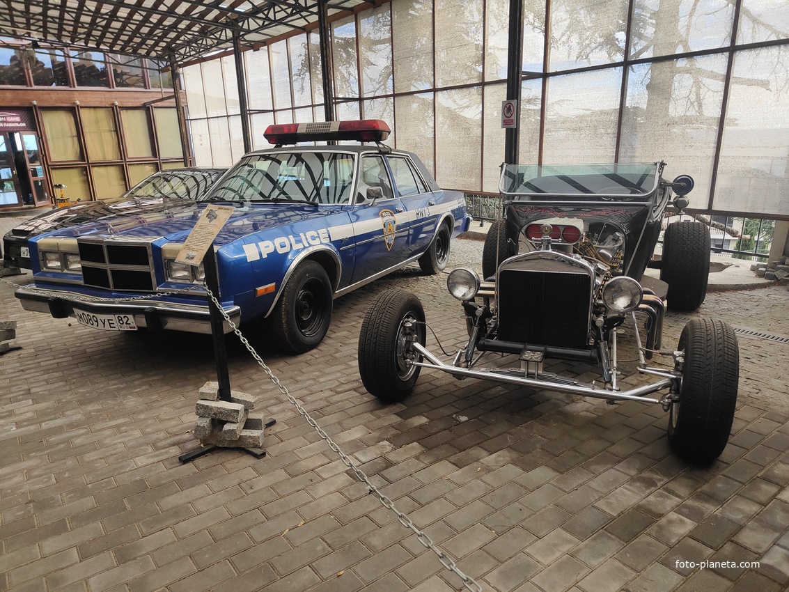 Музей автомобильного искусства. Модель Ford, model А 1929г., построен на базе Ford, model А с двигателем Сhevrolet Corvette. Hot-Rod представляет кастомный проект авто образца 1930-х годов в тематике гангстеров и казино. Слева - Dodge Diplomat SE.