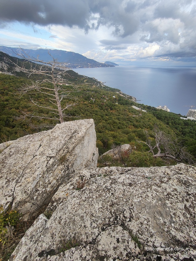 Скальный выступ над одним из обрывов южного склона горного массива Могаби у Стройгородка. Вид на горно-лесистую территорию, побережье к В от Стройгородка.