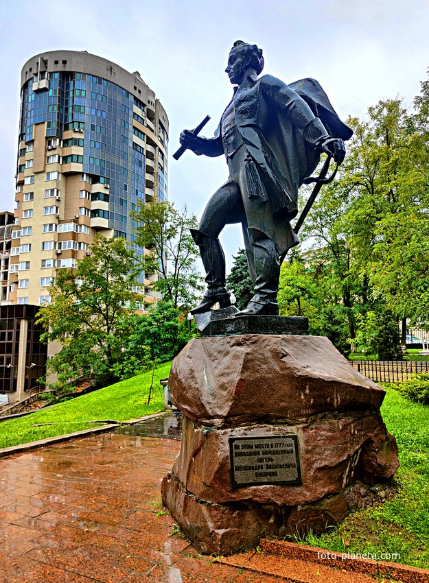 Памятник А.В. Суворову. Открыт в 1984 г. в одноимённом сквере. Автор: скульптор: К. Гордеев, архитектор А. Полегенький. За ним - жилой 16-и этажный дом 28/1 по ул. Набережная имени 60‑летия СССР.