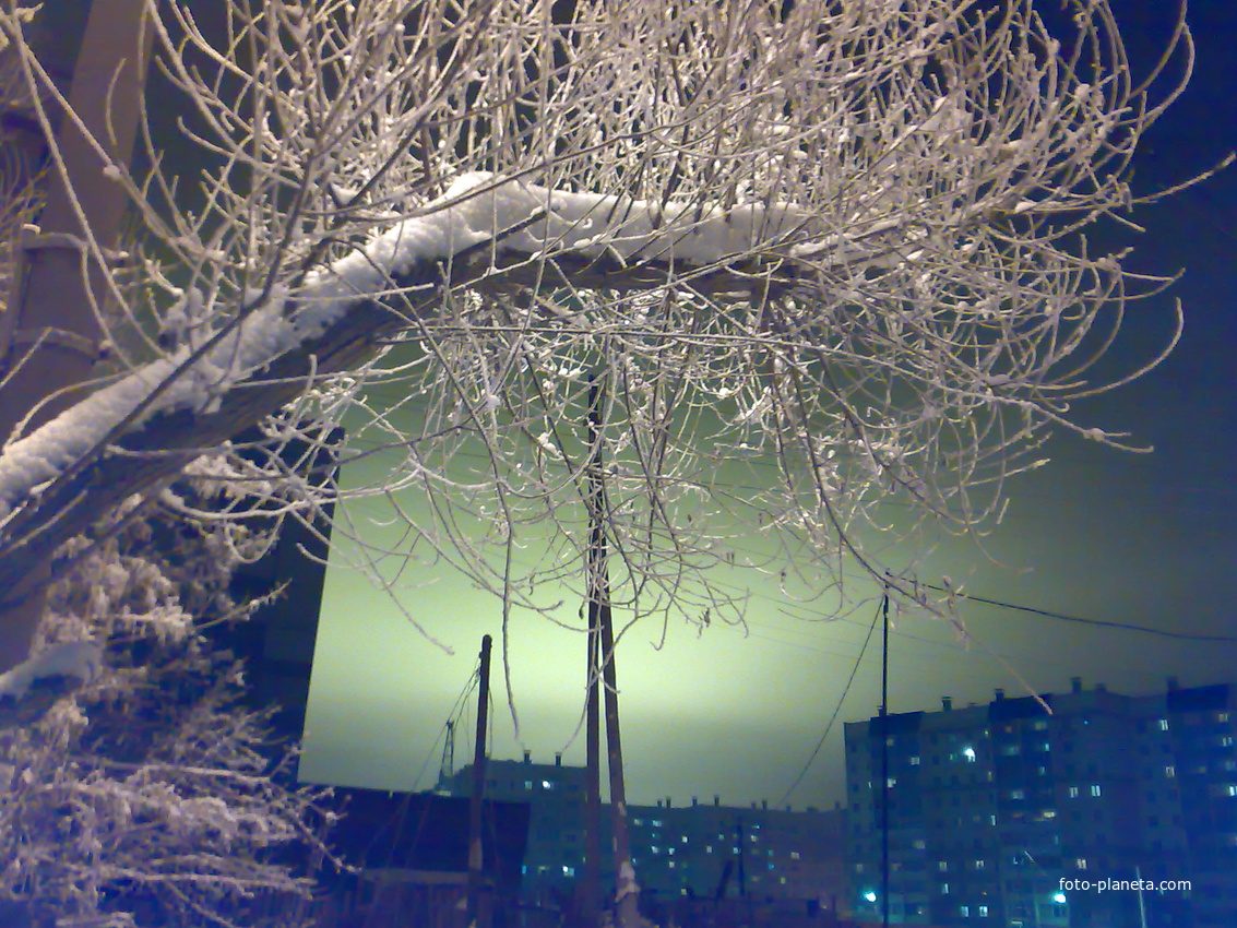 В ночном небе свет от тепличного комплекса, отражающийся в низких облаках.