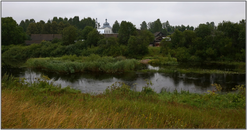 За рекой.